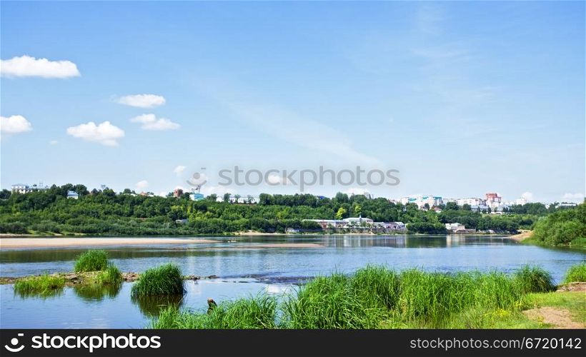 calm river under blue sky at summer day