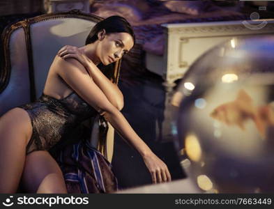 Calm, thoughtful woman resting in the antique armchair