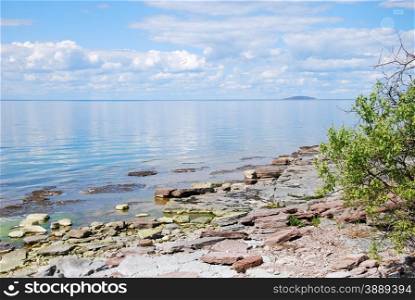 Calm water with cloud reflections by the coast of the swedish island Oland in the Baltic Sea.