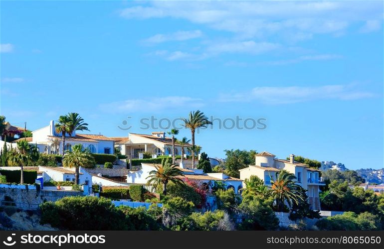 Calp town summer view with palms and blue sky (at Costa Blanca, Valencia, Spain).