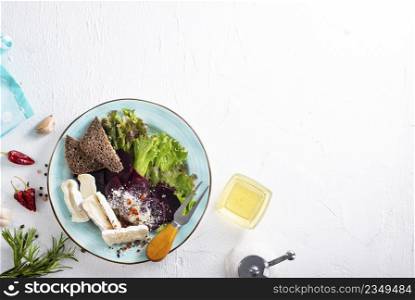 Camamber, beet salad and bread on blue plate