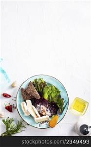 Camamber, beet salad and bread on blue plate