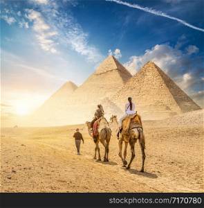 Camel Caravan and the Pyramids of Giza in Egypt. Camel Caravan of Giza