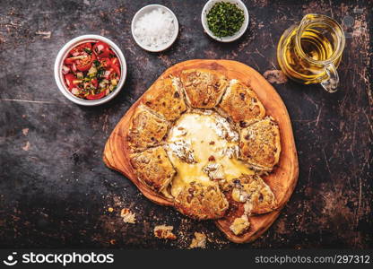 Camembert baked in the oven with herb bread served with tomato salad and olive oil