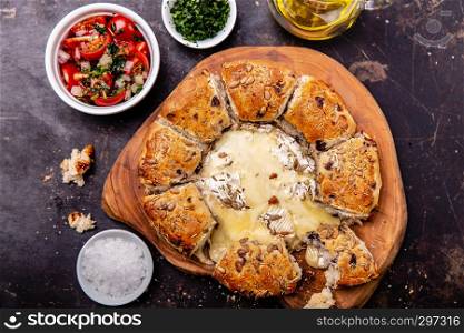 Camembert baked in the oven with herb bread served with tomato salad and olive oil