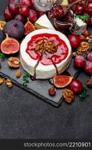 Camembert cheese, cuts and walnuts on stone serving board. Camembert cheese and walnuts on stone serving board