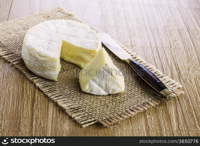 Camembert cheese on a retro wooden desk