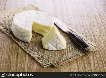 Camembert cheese on a retro wooden desk