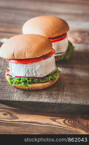 Camembert Hamburgers on the wooden background