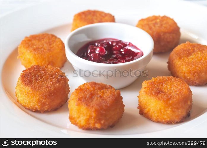 Camembert nuggets with cranberry sauce on the white plate