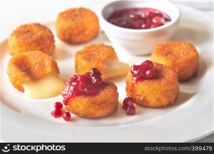 Camembert nuggets with cranberry sauce on the white plate