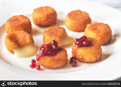 Camembert nuggets with cranberry sauce on the white plate