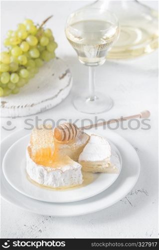 Camembert with honey, grapes and glass of white wine
