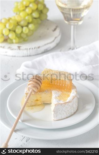 Camembert with honey, grapes and glass of white wine