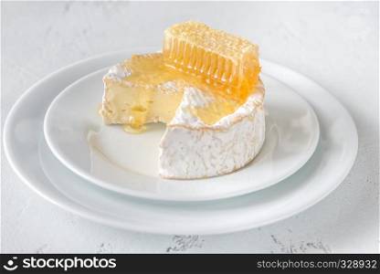 Camembert with honeycombs on the white plate