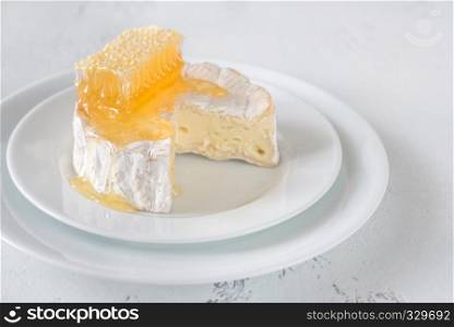 Camembert with honeycombs on the white plate