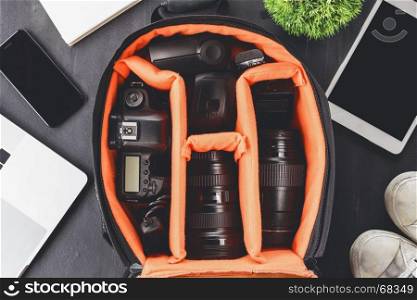 camera gear in bag on top view ready to go travel concept