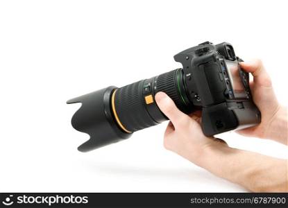 Camera in hand. Close-up of hand holding camera while isolated on white