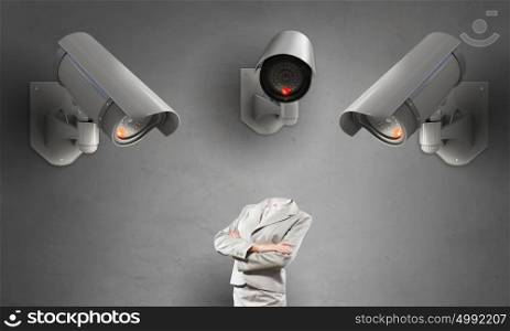 Camera keep an eye on woman. Headless businesswoman in room under CCTV camera control