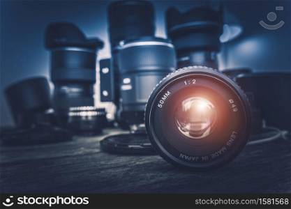 Camera Lens and Photography Equipment in the Background. Photography Concept Photo.