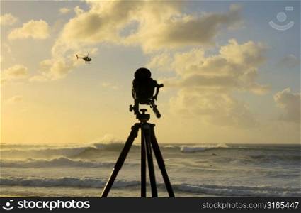 Camera on Beach with Helicopter
