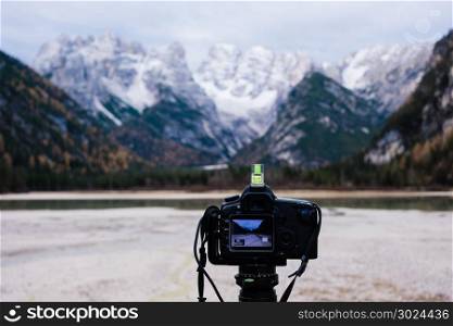 Camera on tripod capturing mountain landscape. Digital camera on tripod capturing mountain landscape