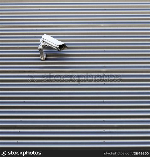 camera on wall of corrugated iron indutrial building