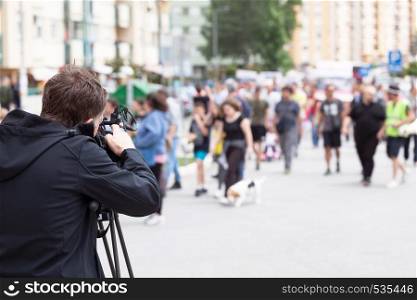 Camera operator filming protesters during street protest