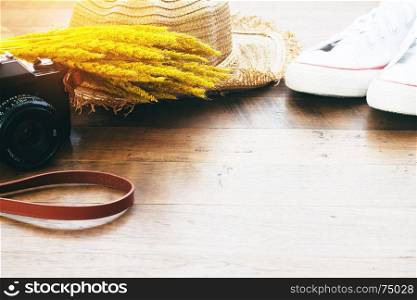 Camera, shoes and straw hat with dried flower, Autumn lifestyle concept with copy space