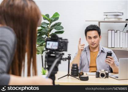 Camera taking video and live with laptop of Asian Vlogger man satisfied the camera lens each media, sharing knowledge to audience via camera by social media channel,vlog and Influencer concept
