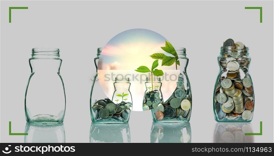 camera viewfinder with focusing the screen of Mix coins and seed in clear bottle on cityscape photo blurred cityscape background, Photographer with business invest concept