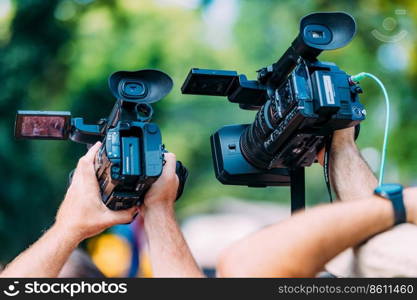 Cameras at a media conference outdoors.. Cameras at a Media Conference