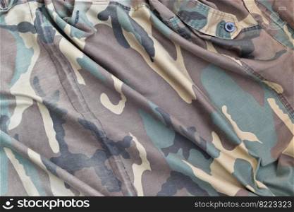 Camouflage background texture as backdrop for military service design projects. Back side of conscripts camouflage jacket with many pleats on crumpled fabric. Camouflage background texture as backdrop for military service design projects