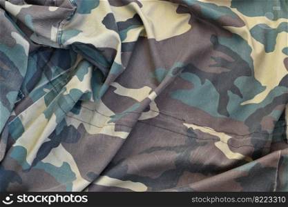 Camouflage background texture as backdrop for paintball and airsoft strikeball design projects. Back side of airsoft players camouflage jacket with many pleats on crumpled fabric. Camouflage background texture as backdrop for paintball and airsoft strikeball design projects