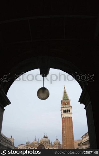 Campanile in Piazza San Marco in Venice, Italy viewed from arched doorway.