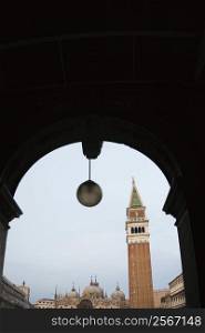Campanile in Piazza San Marco in Venice, Italy viewed from arched doorway.