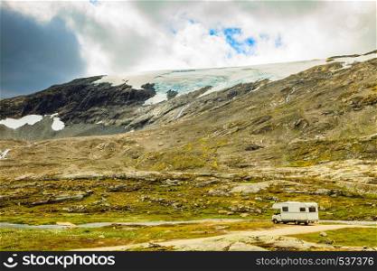 Camper car in norwegian mountains. Camping on nature. Traveling, holidays and adventure concept.. Camper car in norwegian mountains