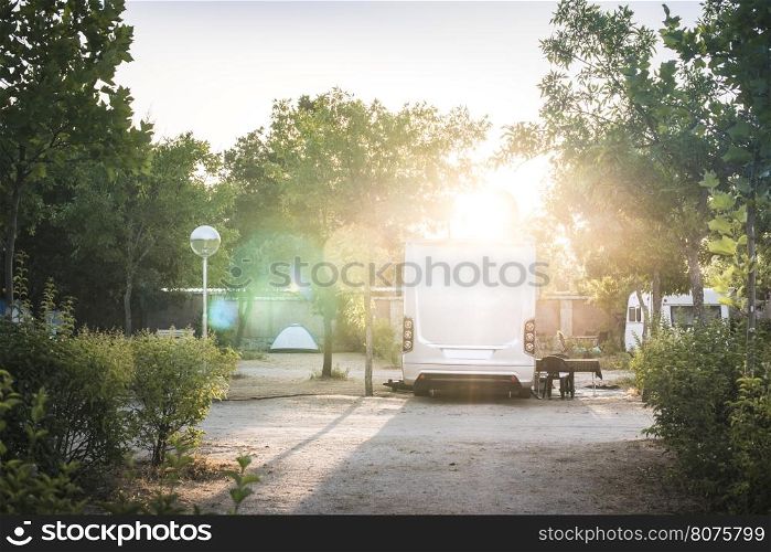 Camper in campsite at the morning sunrise