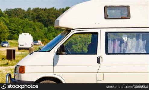 Camper van camping on nature in summer. Traveling by motor home. Caravan vacation.. Camper van camping on nature