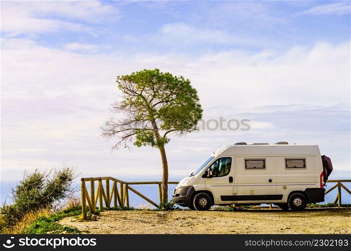 Camper van on spanish coast, seaside cliffs of Maro Cerro Gordo. Costa del Sol, Andalusia Spain. Visiting warm winter travel destinations.. Camper van on seaside cliff, Spain