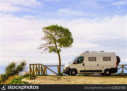 Camper van on spanish coast, seaside cliffs of Maro Cerro Gordo. Costa del Sol, Andalusia Spain. Visiting warm winter travel destinations.. Camper van on seaside cliff, Spain