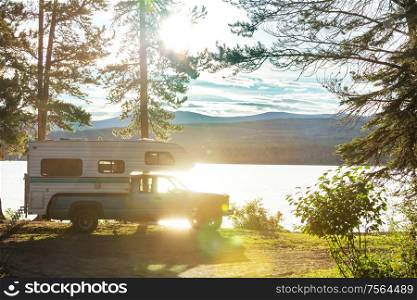 camper van parked on lake shore in mountains. Summer season in Canada.