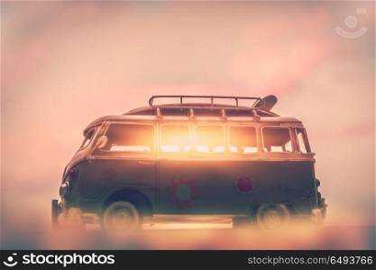 Campervan on sunset, penetrating rays of the sun through the windows of the car, home on the wheels, active summer traveling on minivan. Campervan on sunset