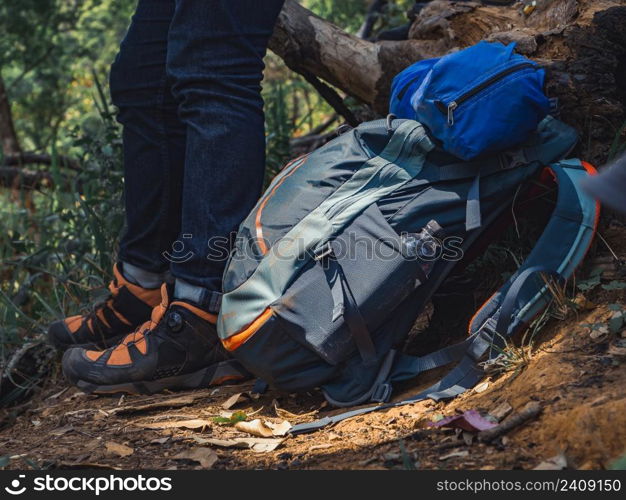 Camping adventure concept from Close up hiking backpack and trekking equipment in forest background.