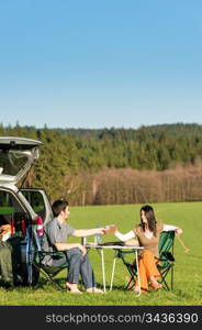 Camping car happy young couple toasting enjoy picnic sunny countryside