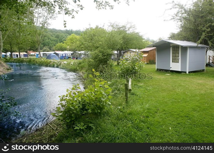 Camping forest green meadow in the river shore