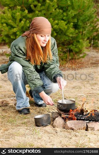 Camping happy woman cook food fire nature