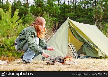 Camping happy woman cook food fire tent nature