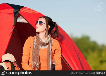Camping happy woman front of tent on beach sunset