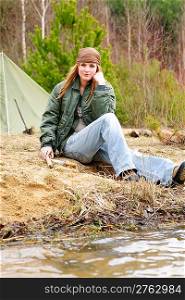 Camping happy woman tent nature sitting by stream